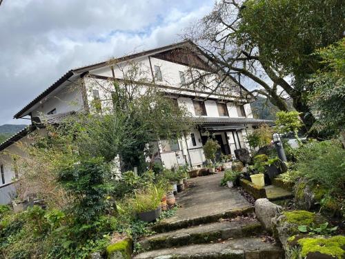 a house on a hill with some plants and stairs at Fukuzawa Ryokan - Vacation STAY 39918v in Sakai