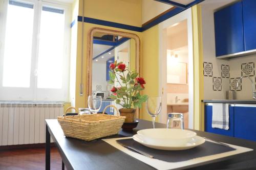 a kitchen with a table with a basket of flowers on it at 1878 Sorrento Guest House in Sorrento