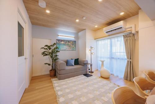 a living room with a couch and a window at Minato Marine Stay in Nagoya