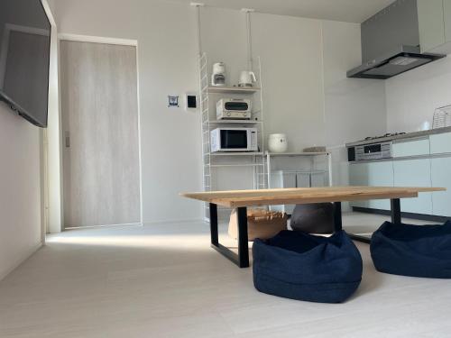 a kitchen with a wooden table in a room at Yuimaru - Vacation STAY 43049v in Bora