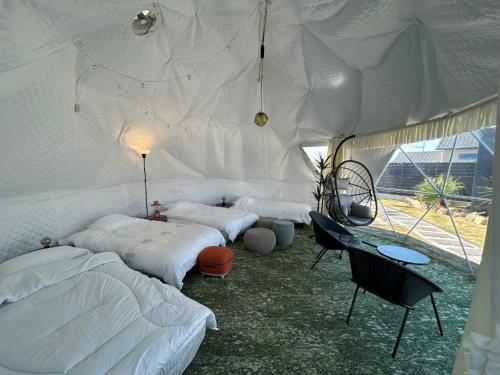 a bedroom with two beds and a desk in a tent at MGBACE - Vacation STAY 19466 in Kubo