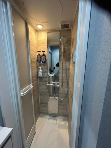 a small bathroom with a shower and a sink at MGBACE - Vacation STAY 19466 in Kubo