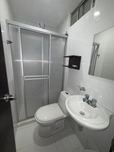 a bathroom with a toilet and a sink and a shower at Nacar Boutique hotel in Valledupar