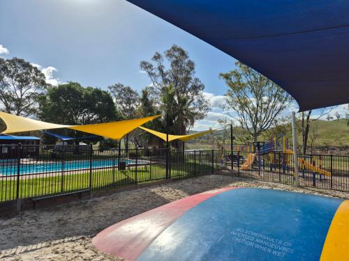 a pool at a park with a playground at Bonnie Doon Caravan Park in Bonnie Doon