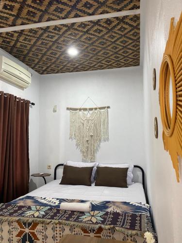 a bedroom with a bed in a room at Batukaras beach hill villas in Batukaras