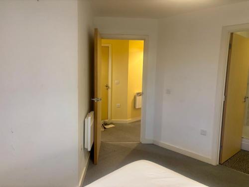 an empty room with two doors and a hallway at Peaceful Urban Retreat in Wolverhampton city in Wolverhampton