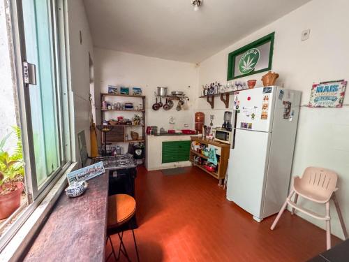 a kitchen with a refrigerator and a table and chairs at CasaDePretaPelo in Salvador