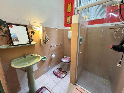 a bathroom with a sink and a shower at CasaDePretaPelo in Salvador