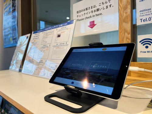 a tablet computer sitting on top of a counter at métisse stay in Nanto