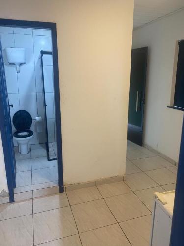 a bathroom with a toilet and a glass door at Cabana Maktub in Uruçuca