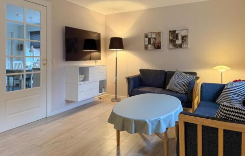 a living room with a couch and a table at Nice Home In Ansager With Wifi in Ansager