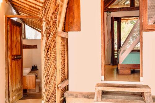 a bathroom in a house with wooden walls at Villa Monyet Java in Batukaras