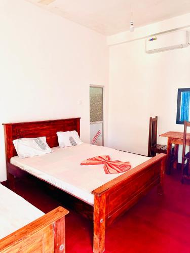a bedroom with a bed with a bow on it at Willow Nest Inn in Mahiyangana