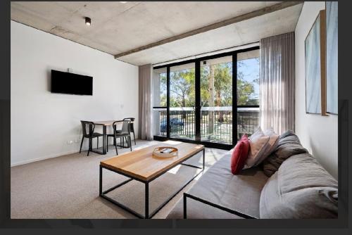 a living room with a couch and a table at Cozy 1BR Apt pet free, free parking Kingston in Kingston