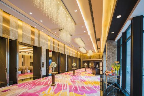 a lobby of a hotel with a colorful carpet at Shangri-La Dalian in Dalian
