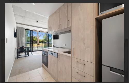 a kitchen with wooden cabinets and a view of a patio at Cozy 1BR Apt pet free, free parking Kingston in Kingston
