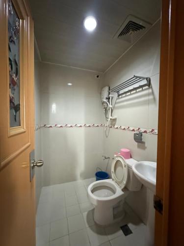 a bathroom with a toilet and a sink at Hotel 45 Extension in Baguio