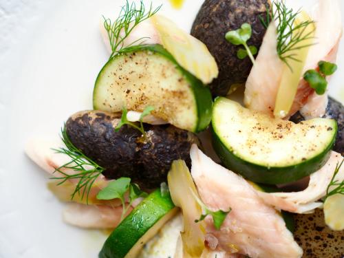 a plate of food with fish and cucumbers on it at Natura Mazur Resort & Conference in Warchały