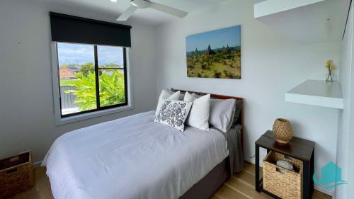 a bedroom with a white bed and a window at Casa Calvi - Central location with Pool in Jewells Station