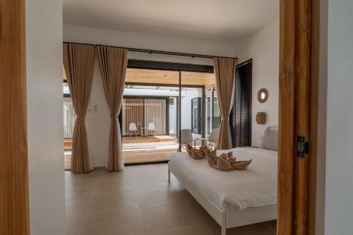 a bedroom with a bed and a large window at Sea Escapes Villas in Thong Sala