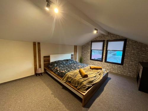 a bedroom with a large bed in a attic at Delight House in Samokov