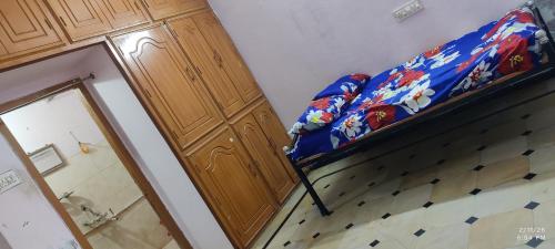a room with a bunk bed and a door with a mirror at Kurnool Homestay in Kurnool