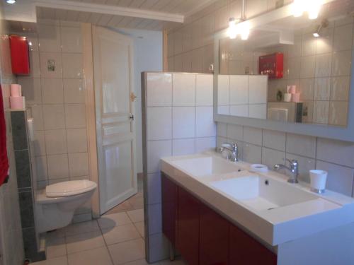 y baño con 2 lavabos, aseo y espejo. en Gite en Forterre, en Druyes-les-Belles-Fontaines