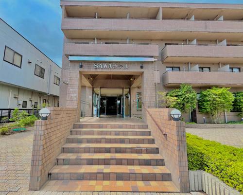 a building with stairs in front of a building at Sawa Hotel in Fujikawaguchiko