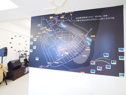 a wall with a poster with a map on it at Love and Peace B&B in Taitung City