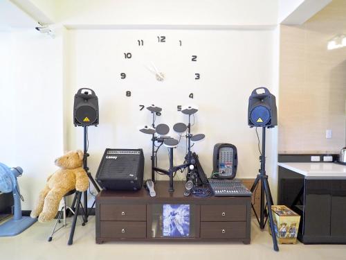 a room with music equipment and a teddy bear at Love and Peace B&B in Taitung City