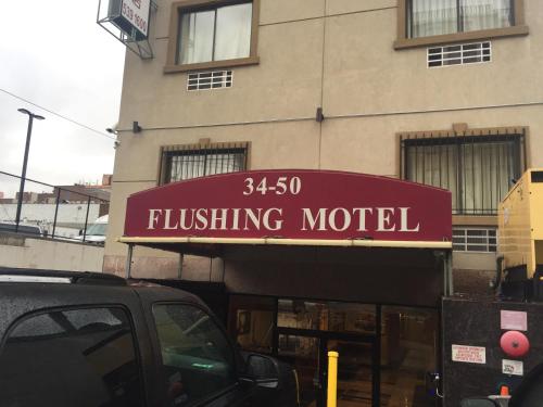 a building with a sign that reads hurdling motel at Flushing Motel in Queens