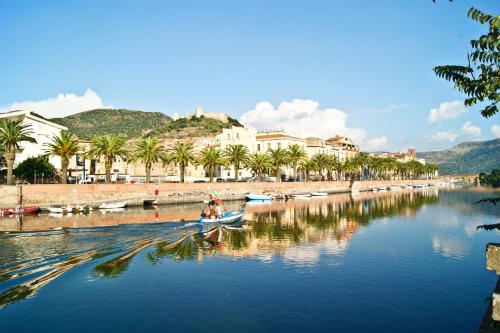 a group of people in a boat on a river at Hotel Miramare in Bosa Marina