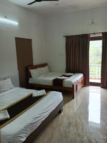 a hotel room with two beds and a window at Prysm Homestay - Kotagiri in Kotagiri