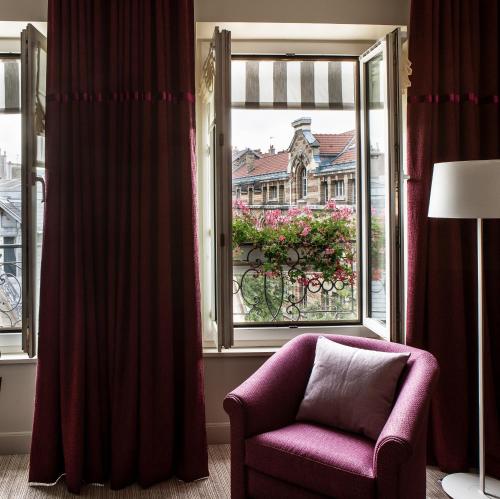 a purple chair sitting in front of a window at Hôtel Parc Saint-Séverin - Esprit de France in Paris