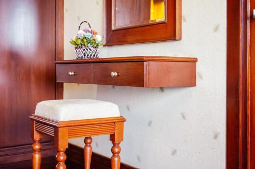 a wooden dresser with a stool and a mirror at Cheeva Pool Villa Phuket in Phuket