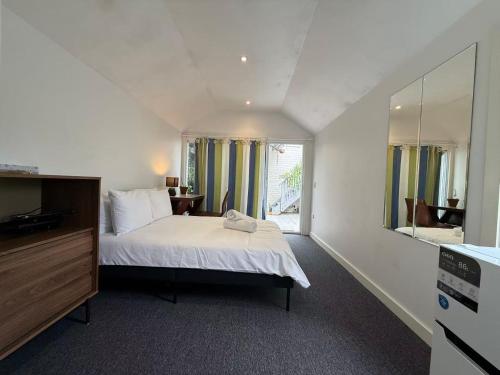 a bedroom with a bed and a large window at Central Chatswood Urban Stay in Sydney