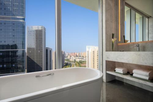 a bathroom with a tub and a large window at Hyatt Regency Xi'An Chanba in Xi'an