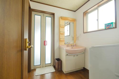 a bathroom with a sink and a mirror at 空海の宿平生 in Saga