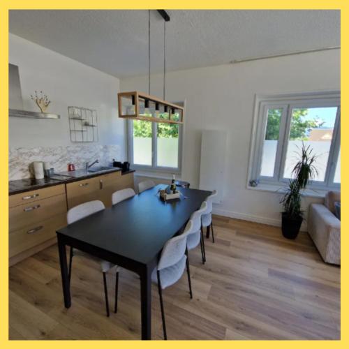a kitchen and dining room with a table and chairs at La Parenthèse Léman in Neuvecelle