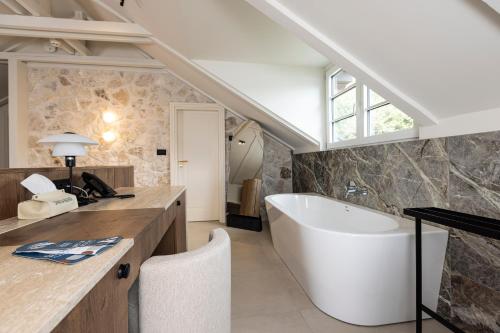 a bathroom with a large tub and a sink at Santa Boka Small Luxury Hotels of the World in Perast