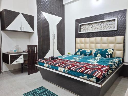 a bedroom with a bed and a desk in it at Angel's Cottage in Jaipur