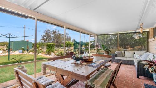 a living room with a wooden table and a couch at Driftwood At Beachmere in Beachmere