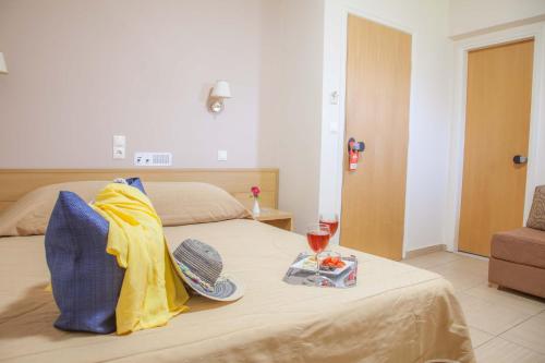 a bed with a tray of food and a glass of wine at G George in Nydri