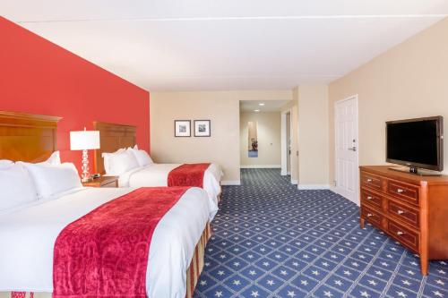 a hotel room with two beds and a flat screen tv at Wyndham Gettysburg Hotel & Conference Center in Gettysburg