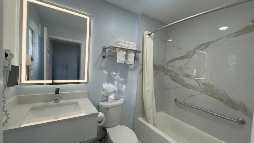 a bathroom with a sink and a toilet and a shower at Pelican Inn in Monterey