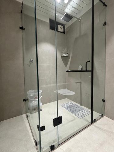 a bathroom with a glass shower with a toilet at Hotel Annant Jawai in Sheoganj