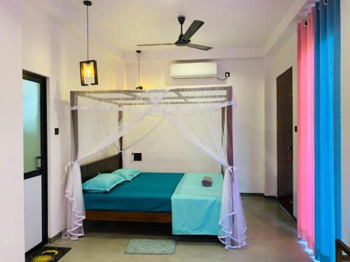a bedroom with a bed with a canopy at The Ondoro in Kamburugamuwa
