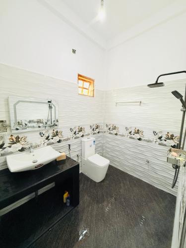 a bathroom with a toilet and a sink at Dew homestay in Wellawaya