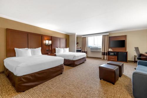 a hotel room with two beds and a television at Comfort Suites Elizabethtown in Elizabethtown