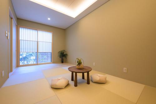 a living room with a table and a large window at TEMARI Premier NORTH in Hakone